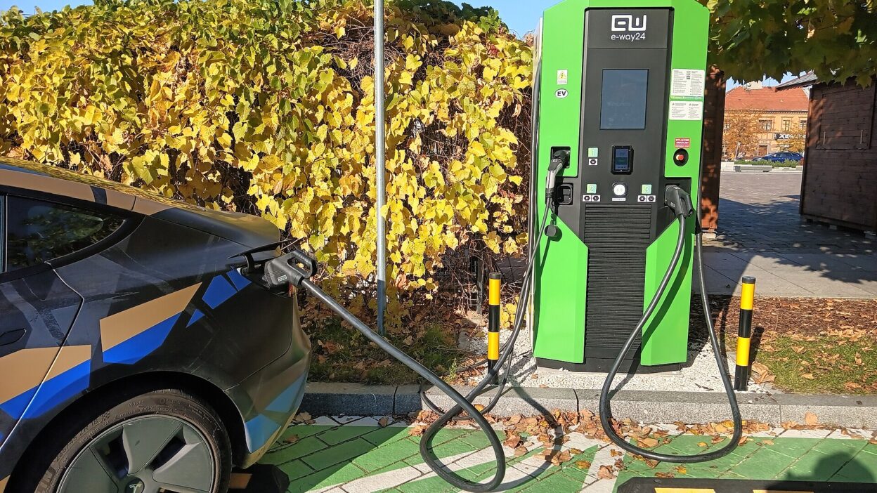Tesla 3 charging at the electric car charging station in Tomaszów Mazowiecki, Kościuszki 11 Square. – Tesla lízing Magyarországon