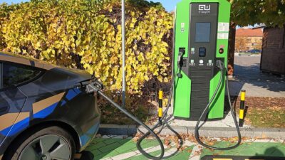 Tesla 3 charging at the electric car charging station in Tomaszów Mazowiecki, Kościuszki 11 Square. – Tesla lízing Magyarországon